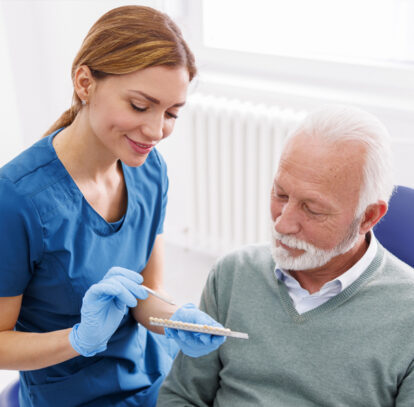 Dentist explaining to the patient about different types of shades of dental veneers in Oshawa, ON.