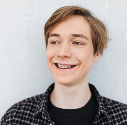 Smiling man looking comfortable in dental braces in Oshawa, ON.