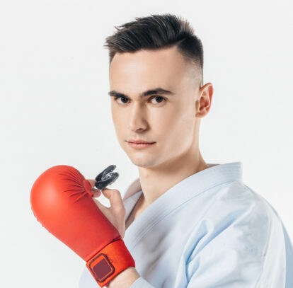 Sports person holding custom made sports guard in Oshawa, ON.